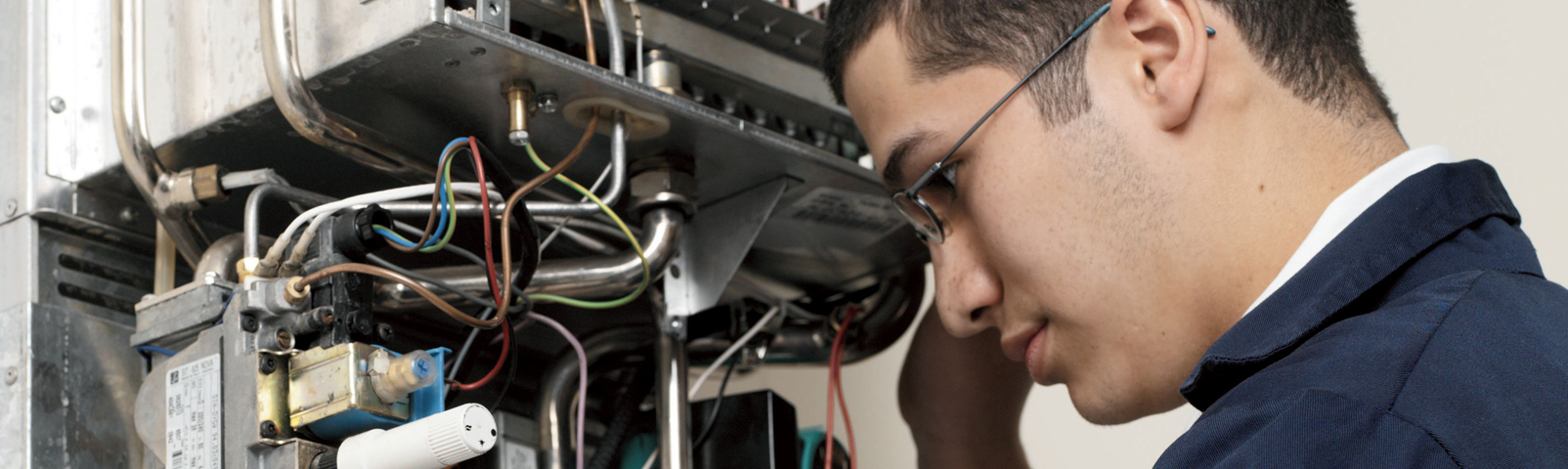 Apprentice working on boiler